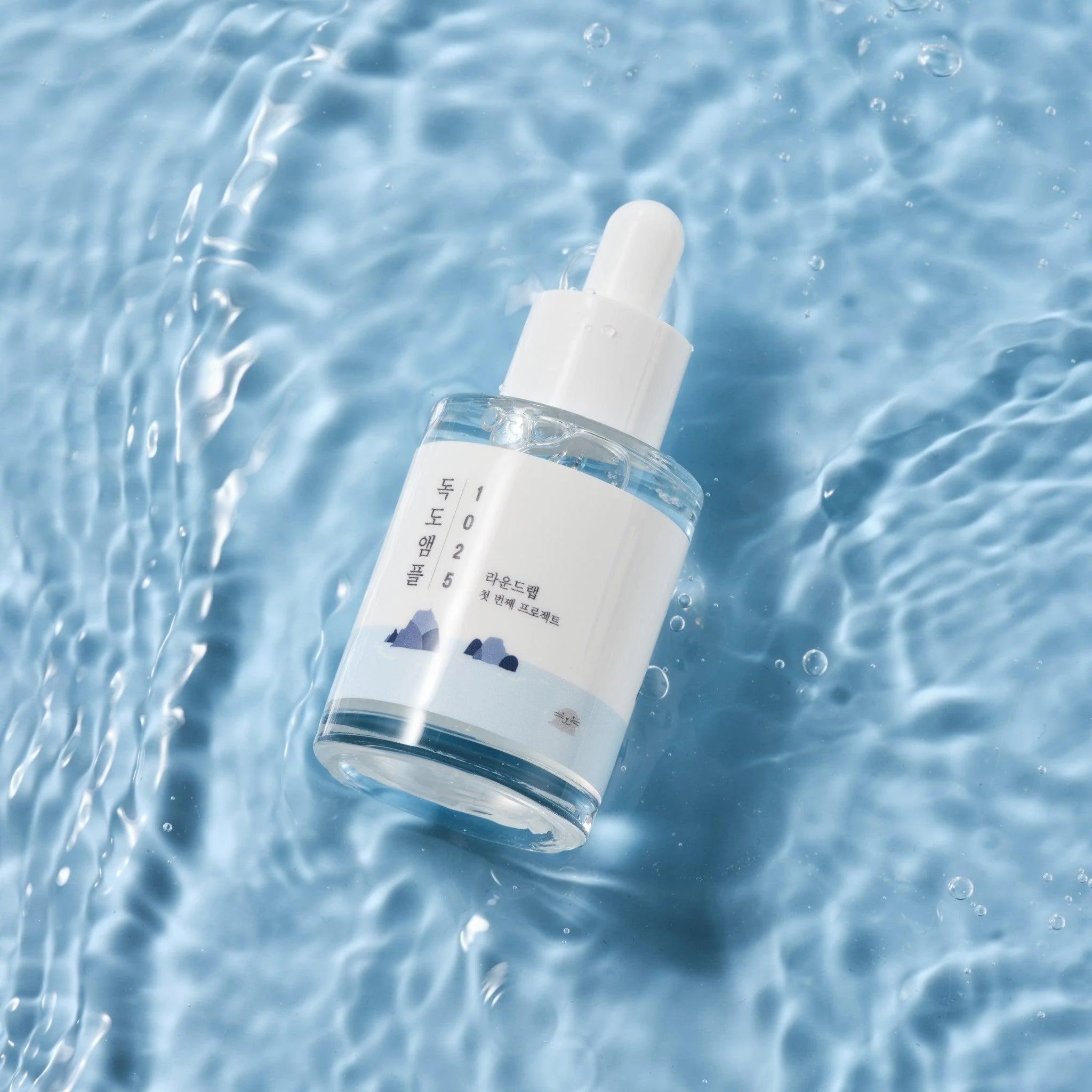 Dokdo-ampul met pipet, doorzichtige fles met blauw etiket