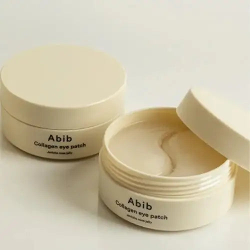 Abib Collagen Eye Patch Jericho Rose Jelly Abib collagenoogpatch pot met open deksel en gestapelde oogpatches.