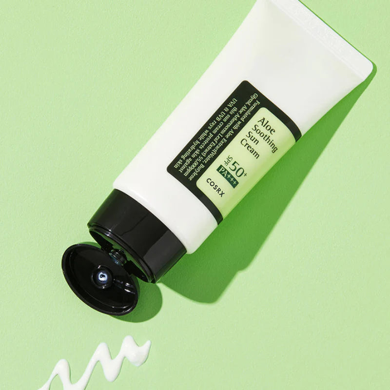 COSRX Aloe Soothing Sun Cream SPF50+ tube met textuur op groene achtergrond