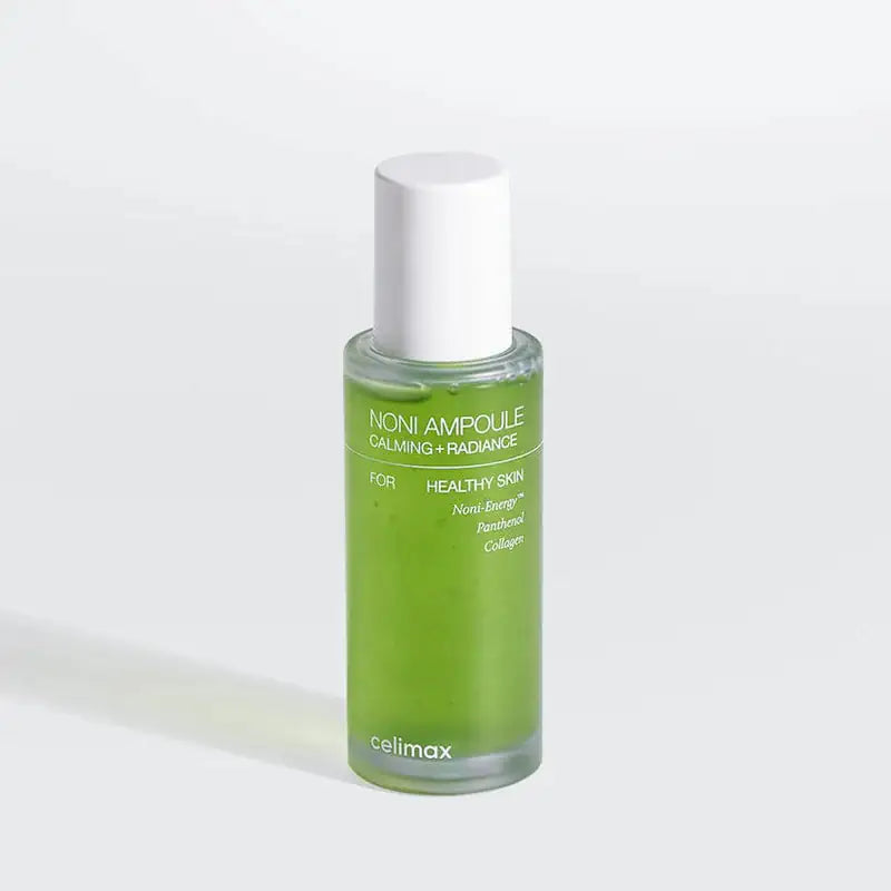 Celimax Noni Energy Ampoule Noni Energy-ampulflacon met witte dop en groene vloeistof; celimax logo onderaan.