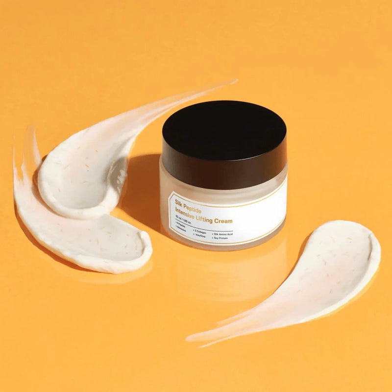 SUNGBOON EDITOR Silk Peptide Intensive Lifting Cream 50 ml met witte crèmestreken op een oranje achtergrond.