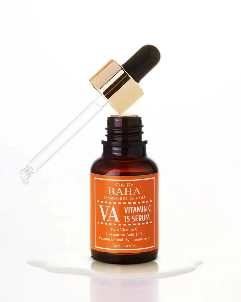 Vitamine C-serumfles met zwarte dop en gouden pipet, met witte vloeistofspat.