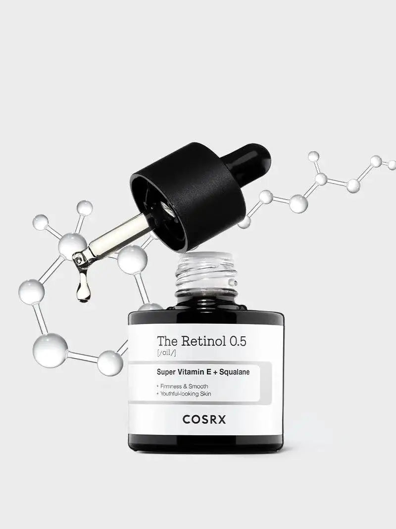 Retinol-olieflacon met zwarte dop en druppelaar, druppel boven het flesje